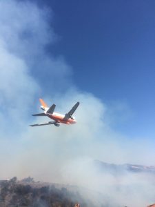 A firefighting airplane preparing to make a drop over the burning Soberanes Fire